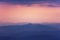 Silhouettes of mountains the evening light with haze in the atmosphere, perspective aerial view