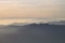 Silhouettes of mountains in the middle of the fog and clouds at