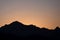 Silhouettes of mountains with an orange color of sunset and sunrise. Forest silhouettes