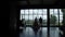 Silhouettes of newlyweds in front of big window