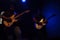 Silhouettes Pair of young guitarists playing the electric guitars on stage in Mexico City