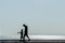 Silhouettes of parents with baby on the sea background