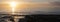 Silhouettes of people on beach at Ault in french normandy during sunset