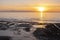 Silhouettes of people on beach at Ault in french normandy during sunset