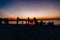 Silhouettes of people on the beach. Launching rice paper hot air balloons in the sky at sunset on a beach in Thailand