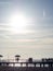 Silhouettes of people on the bridge on the seashore. People see off the sunset. Sea coast. Pier on the sea