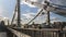 Silhouettes of people and cars on the steel bridge