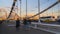 Silhouettes of people and cars on the steel bridge