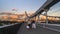 Silhouettes of people and cars on the steel bridge