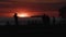 Silhouettes of people on the city promenade during sunset