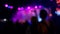 Silhouettes of people at a concert, defocused background