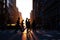 Silhouettes of people crossing a busy intersection on 5th Avenue in New York City with sunset in the background