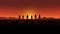 Silhouettes of people in desert sunset