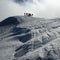 Silhouettes of people hiking on a snowy hill to ski in winter