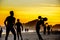 Silhouettes of people playing beach football on the background of beautiful golden sunset at Copacabana beach, Rio de Janeiro