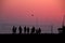 Silhouettes of people playing volleyball at sunset