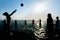 Silhouettes of people playing volleyball in water