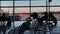 Silhouettes of people sitting in the airport lounge before departure. Airplanes stand behind the glass. panoramic camera