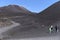 Silhouettes of people standing on a slope of Etna - the highest active volcano in Europe