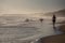 Silhouettes of a people and surfers at the beach.