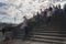 Silhouettes of people walk the stairs of the stone bridge