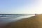 Silhouettes of people walking along Playa del Ingles on Gran Canaria