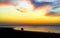 Silhouettes of people walking on the beach at sunset. Epic dramatic sunset.