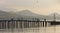 The silhouettes of the pier,boats,fishermen on the background of the mountains and Bay.