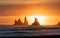 Silhouettes of Reynisdrangar sea stocks in Vik Iceland against the bright golden sunset