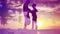 Silhouettes of Romantic Love Couple Meeting in Sunset, Kissing and Hugging