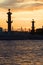 The silhouettes of the Rostral columns at sunset. Saint Petersburg