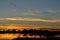 Silhouettes of Sandhill Cranes Flying After Sunset