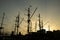 Silhouettes of ship masts on the sunset sky background