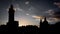 Silhouettes shot of astronomical clock tower and dome of St. Nicholas church