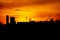 Silhouettes shot of sunset or evening time at city town with building roof or tower or Satellite dish.