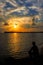 Silhouettes of single men sitting lonely on the beach