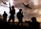 Silhouettes of soldiers with assault rifles and military airplanes patrolling