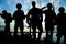 Silhouettes of soldiers with assault rifles patrolling. Military service