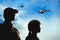 Silhouettes of soldiers in uniform and military helicopters patrolling