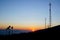 Silhouettes telecommunication tower at sunrise