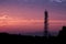 Silhouettes telecommunication tower at sunrise and twilight sky.