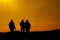 Silhouettes of three fishermen