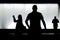 Silhouettes of three people in the night