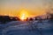 Silhouettes of tourists backlit in the setting sun at Strokkur geyser with the setting sun on the horizon illuminating the vapors