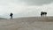 Silhouettes of tourists with Hiking backpacks in snowy mountains