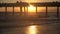 Silhouettes of tourists on a pier during a brilliant sunset