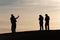 Silhouettes of tourists taking pictures at sunset in the Sahara desert Morocco