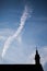 Silhouettes of towers and architectural parts with blue sky and white clouds