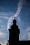 Silhouettes of towers and architectural parts with blue sky and white clouds