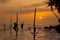 Silhouettes of the traditional Sri Lankan stilt fishermen